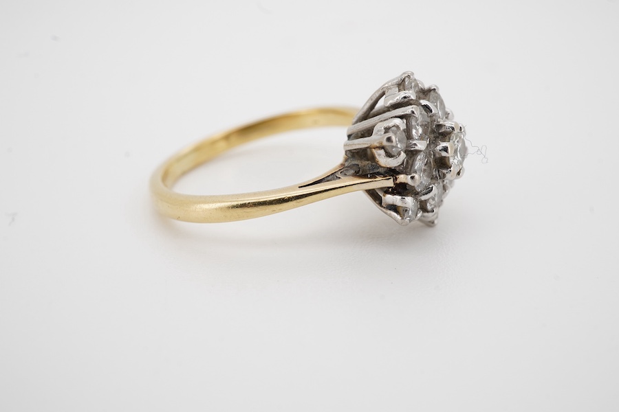 A yellow metal (stamped 18ct) and diamond set flower head cluster ring, size M, gross weight 4.1 grams. Condition - fair to good